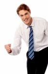 Enthusiastic Corporate Man Clenching Fist Stock Photo