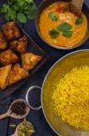 Indian Pilau Rice In Balti Dish Served With Chicken Tikka Masala Stock Photo