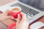 Red Coffee Cup On Work Station Stock Photo