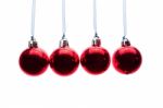 Red Christmas Balls Hanging In A Row On White Background Stock Photo