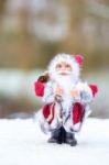 Model Of Santa Claus Standing In White Snow Outdoors Stock Photo