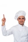 Male Chef Looking And Pointing Upwards Stock Photo