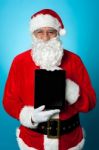 Father Christmas Presenting A New Tablet Device Stock Photo