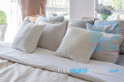 Earth Tone Color Pillows In Luxury Bedroom Stock Photo