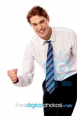 Enthusiastic Corporate Man Clenching Fist Stock Photo