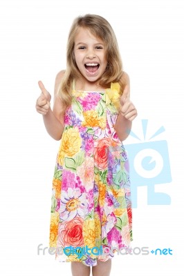 Excited Young Girl Showing Double Thumbs Up Stock Photo