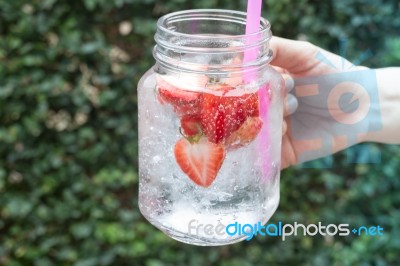 Hand Hold Glass Of Iced Strawberry Soda Drink Stock Photo