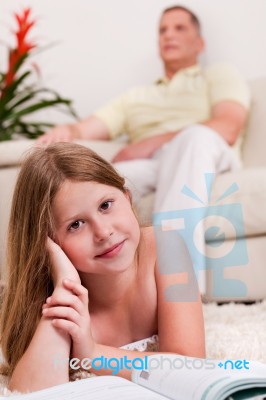 Little Girl Lying With Book Stock Photo