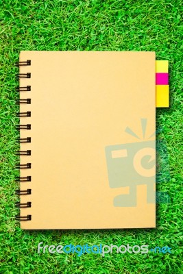 Notebook On Grass Stock Image