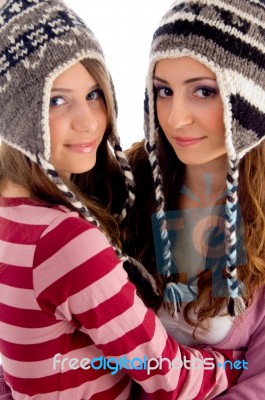 Two Young Friends Wearing Woolen Cap And Looking At Camera Stock Photo