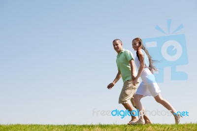 Young Couple Running Stock Photo
