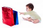 Baby Trying To Pull The Shopping Bag Stock Photo