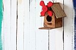 Colorful Bird House On Grunge Wall Stock Photo