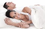 Couple Lying In Bed Together Stock Photo
