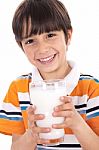 Happy Kid Holding A Glass Of Milk Stock Photo