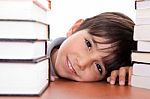Happy Young School Boy Surrounded By Books Stock Photo