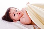 Little Baby Lying In White Towel And Wrapped With Yellow Towel Stock Photo