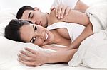 Loving Husband And Wife Lying In Bed Stock Photo