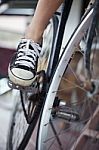 Person Riding A Vintage Bicycle, Close Up View Of Sneaker Shoe A Stock Photo