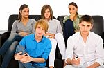 Teenagers holding TV remote Stock Photo