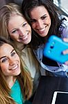 Three Friends Taking Photos With A Smartphone Stock Photo