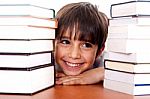 Young Kid Relaxing Between Pile Of Books Stock Photo