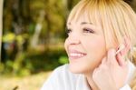 Woman In The Park With Earphones Stock Photo