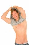 Young Man Removing T Shirt Stock Photo