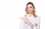 Charming Woman Pointing By Her Side Stock Photo