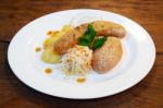 Sausages With Vegetables On A Plate Stock Photo