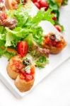 Original Italian Fresh Bruschetta Served With Fresh Salad And Ve Stock Photo