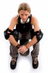 Male Skater Resting On Skateboard Stock Photo