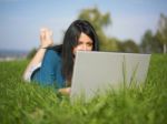 Young Woman Using Laptop In Park Stock Photo