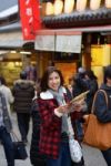 Smiling Woman Tourist Hold Map Stock Photo