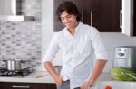 Man Smiling In Kitchen Stock Photo