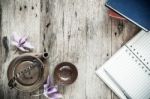 Open Notebook And Pen With Teapot On Old Wooden Background Stock Photo