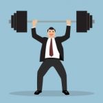 Businessman Lifting A Heavy Weight Stock Photo