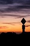 Road Sign Silhouette And Colorful Sunset Stock Photo