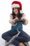 Young Woman With Remote And Christmas Hat Stock Photo