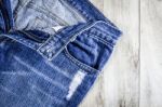 Blue Jeans On Old Wooden Background Stock Photo