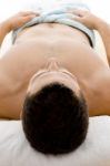 Man Lying Down For Spa Treatment Stock Photo