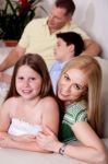 Family Of Four Relaxing At Home Stock Photo