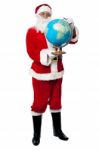 Male Santa Holding A Globe Map Stock Photo