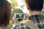 Loving Traveler Couple Taking Pictures Using Mobile Phone Photog Stock Photo