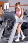 Woman On Running Machine In Gym Stock Photo