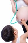 Pregnant Woman Examining Her Tummy Stock Photo