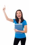 Excited Young Student Raising Her Hand Stock Photo