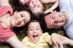 Parents And Kids Laying Stock Photo