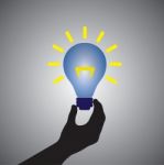 Person Holding Idea Lightbulb Stock Photo