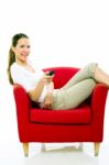 Woman With Remote Control On Sofa Stock Photo